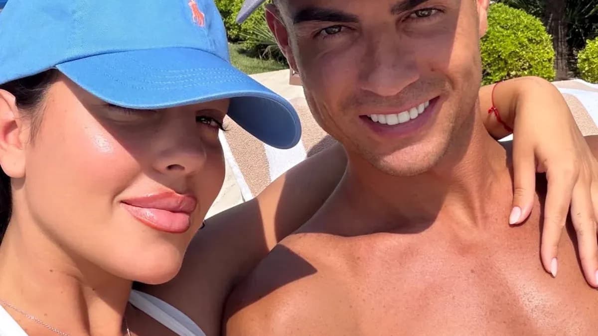 Couple posing together in sunny outdoor setting