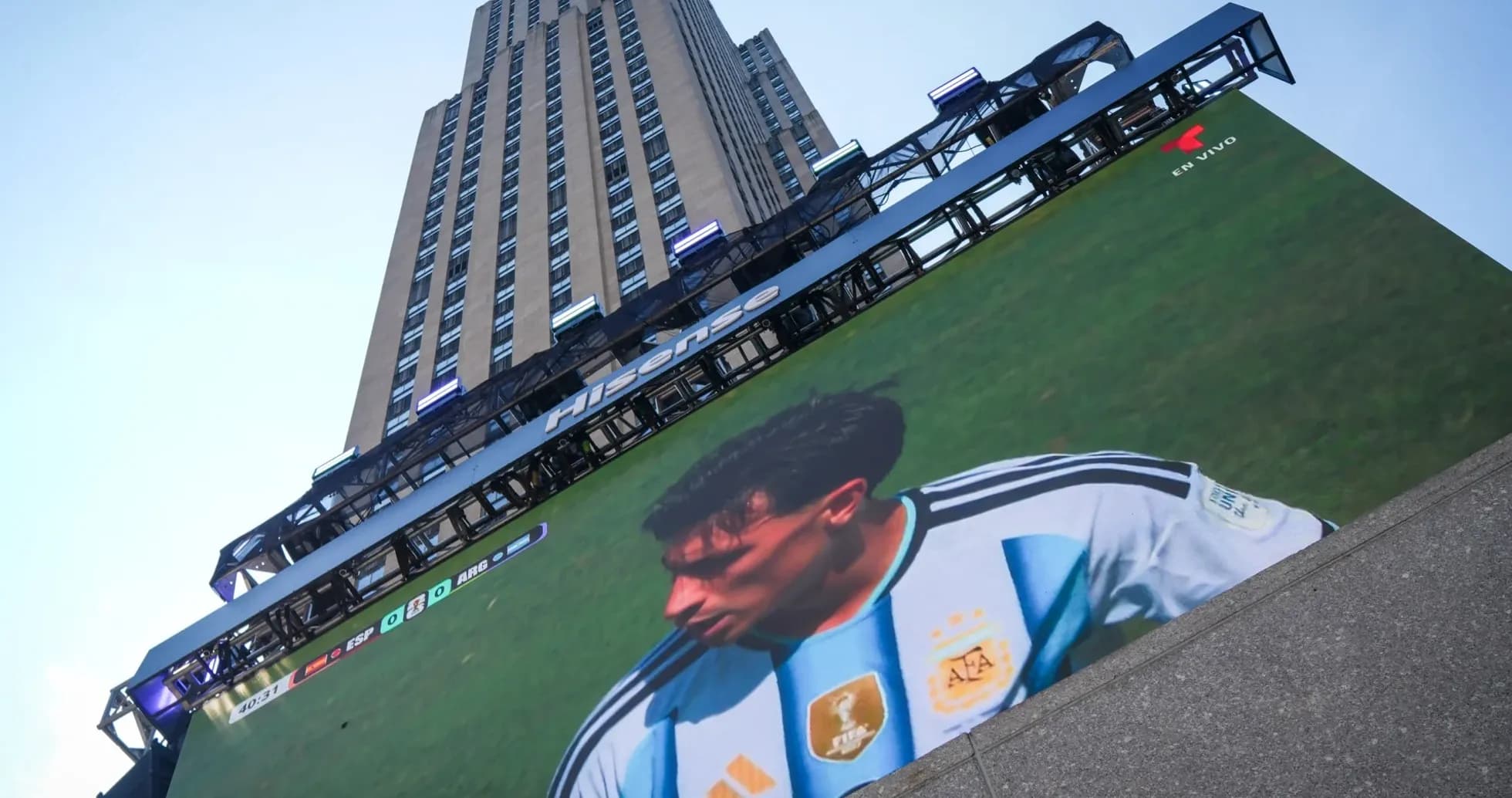 Large screen displaying football match at skyscraper