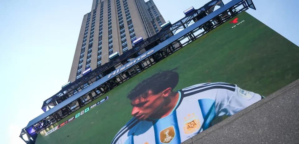 Large screen displaying football match at skyscraper