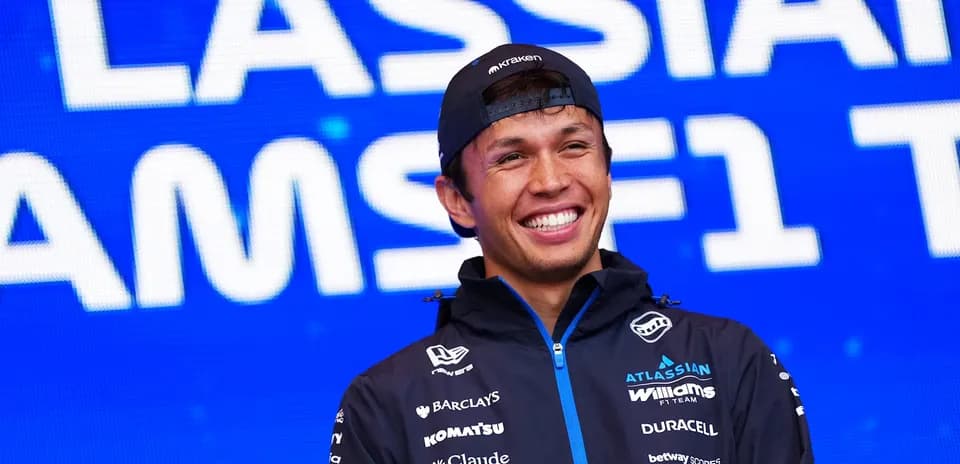 Pilot smiling on stage at event backdrop