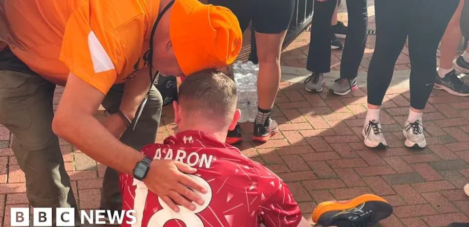 Supporter assisting athlete sitting on ground