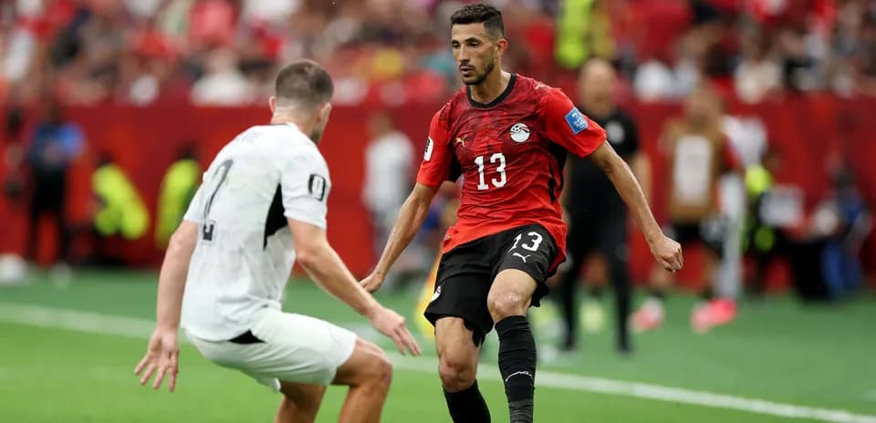 Egyptian player dribbling past opponent during match