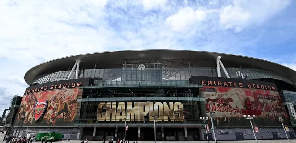 Emirates Stadium exterior with 'CHAMPIONS' signage