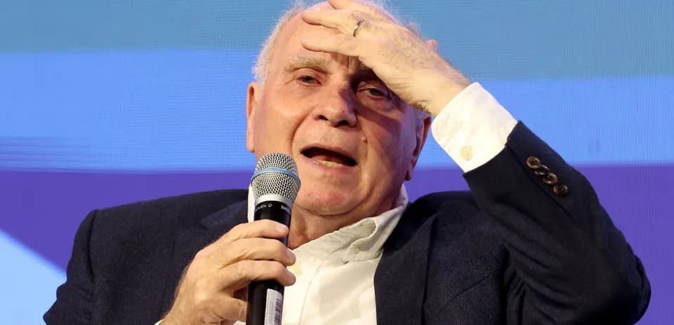 Speaker gesturing while holding microphone at event