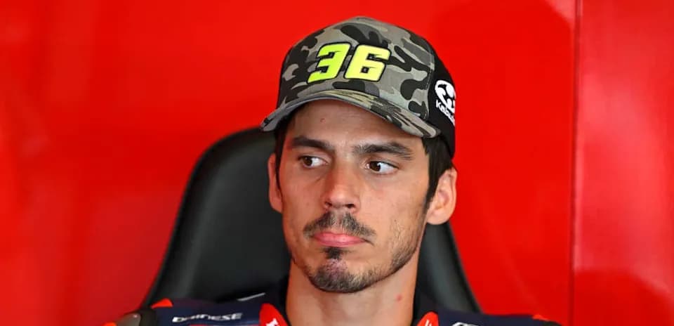 Motorsport rider wearing cap in team garage