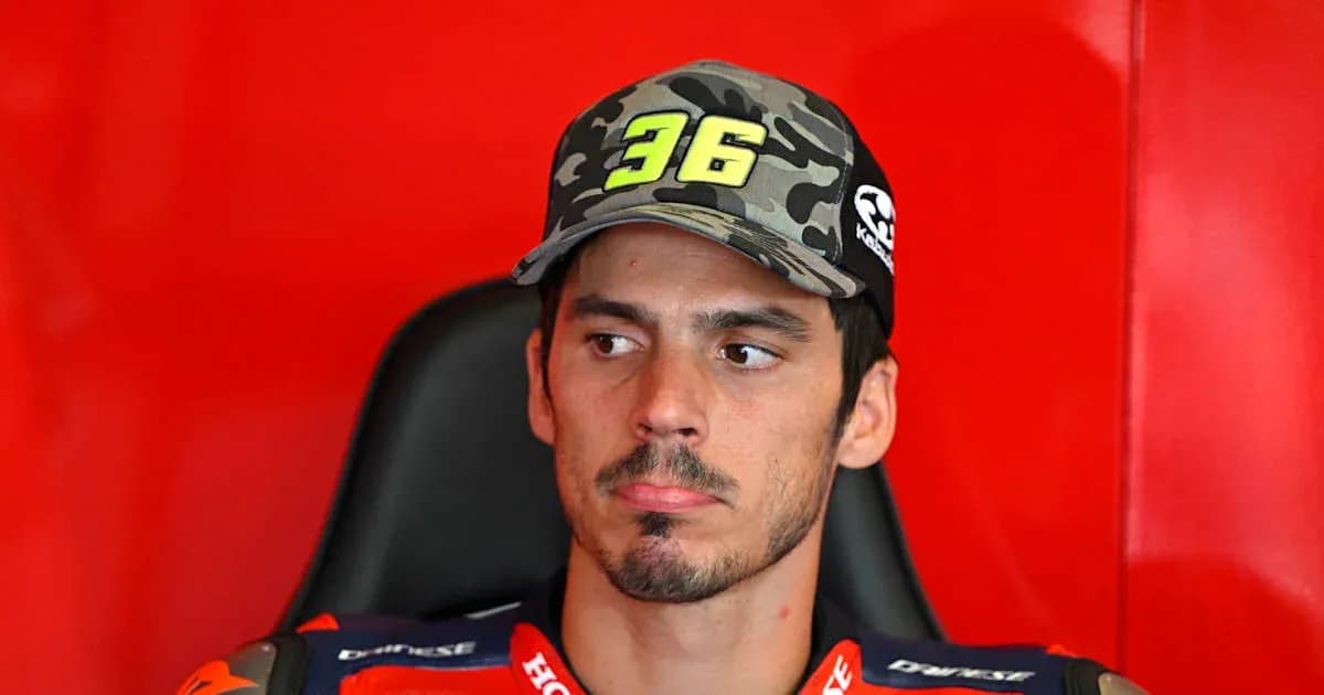 Motorsport rider wearing cap in team garage