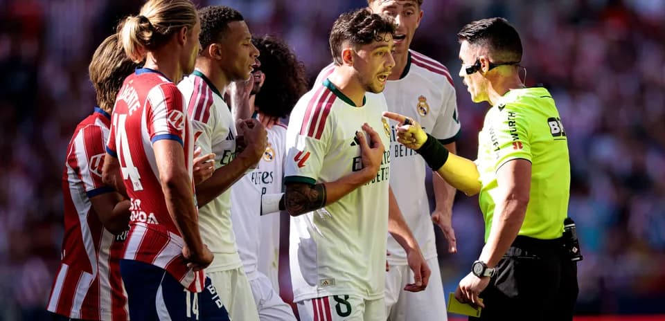 Real Madrid players arguing with referee during match