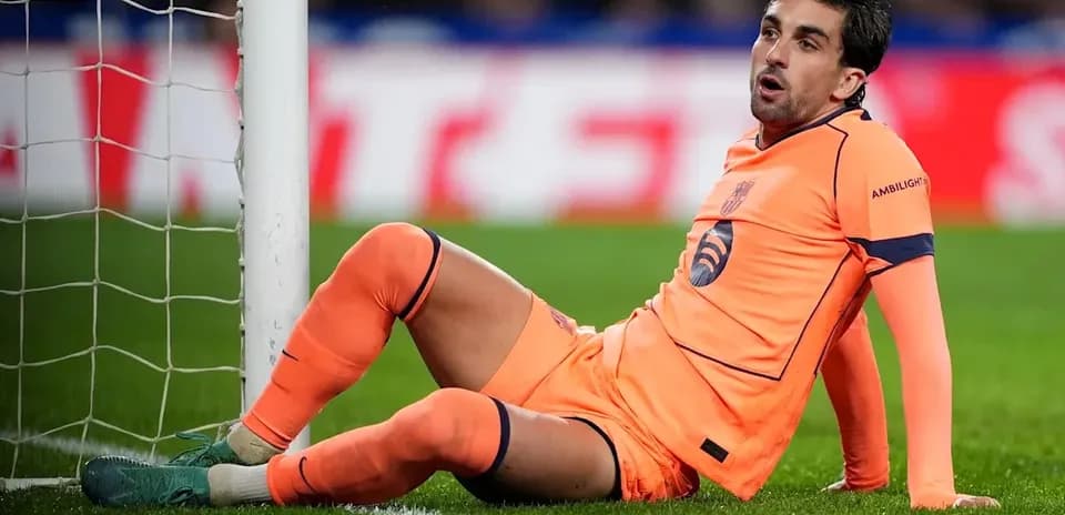 Goalkeeper sitting by the goal post during match