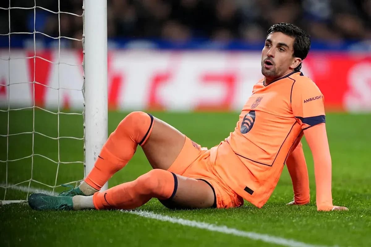 Goalkeeper sitting by the goal post during match