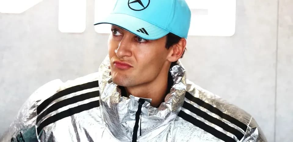Pilot wearing silver jacket and blue cap