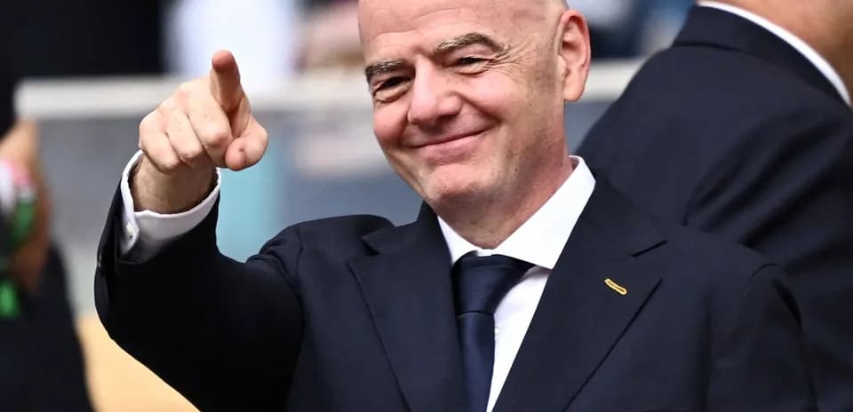 FIFA president pointing and smiling at event
