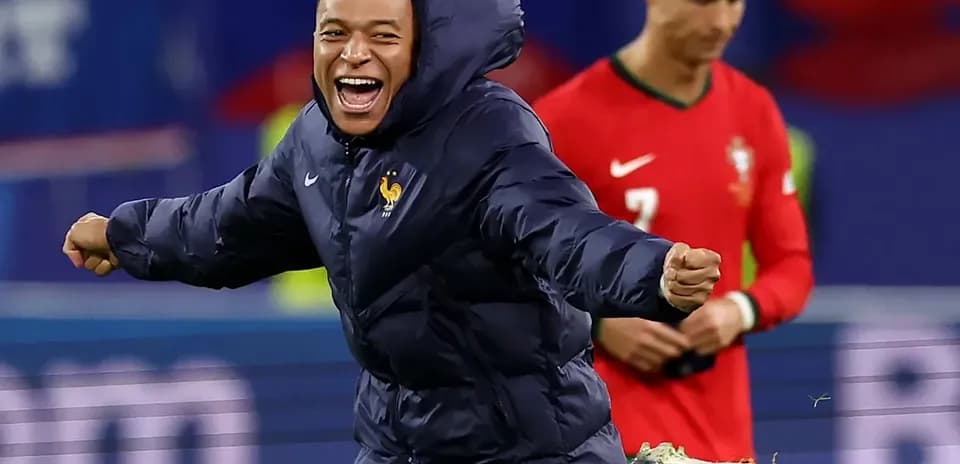 Kylian Mbappé celebrating with teammates during match