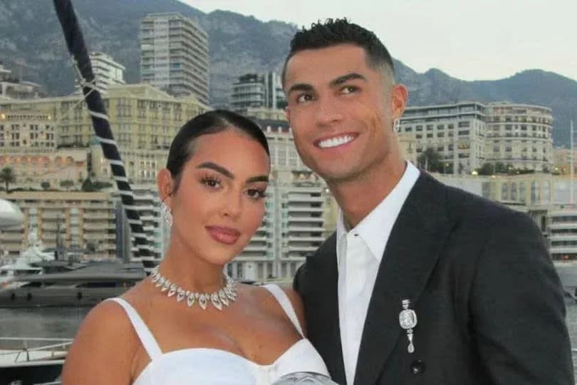 Couple posing together with cityscape background