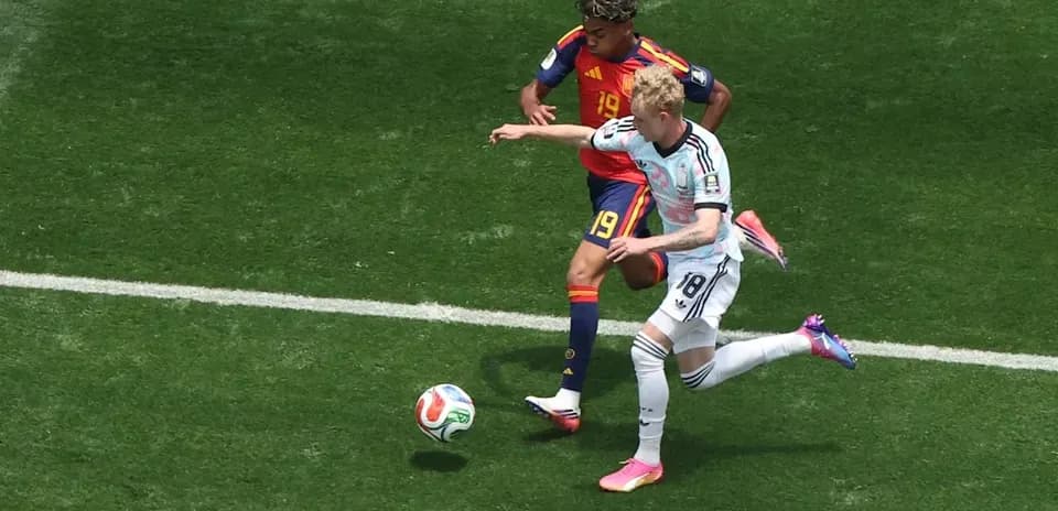 Two players contesting the ball during football match