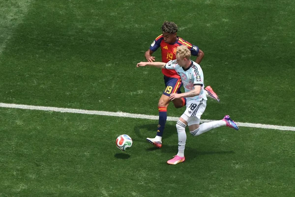 Two players contesting the ball during football match