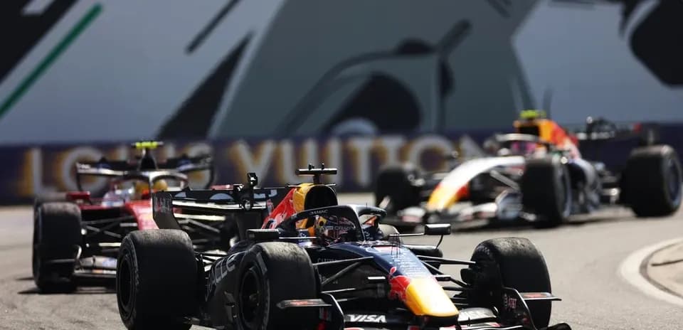 Formula 1 cars racing on a circuit track