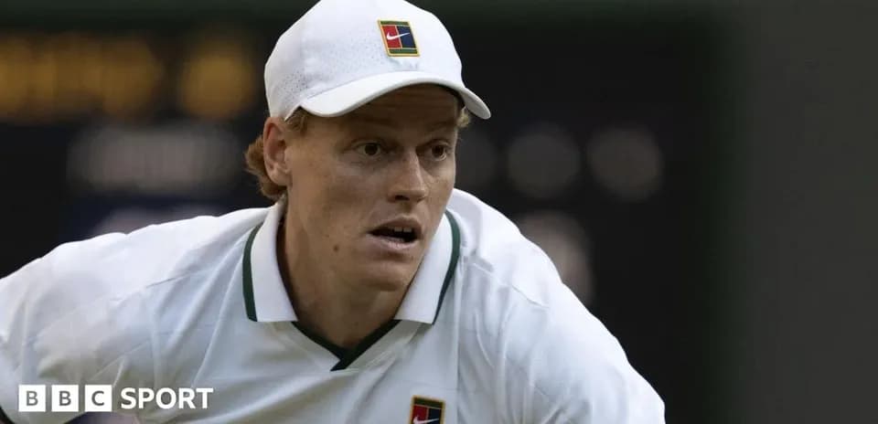 Tennis player preparing to serve on court