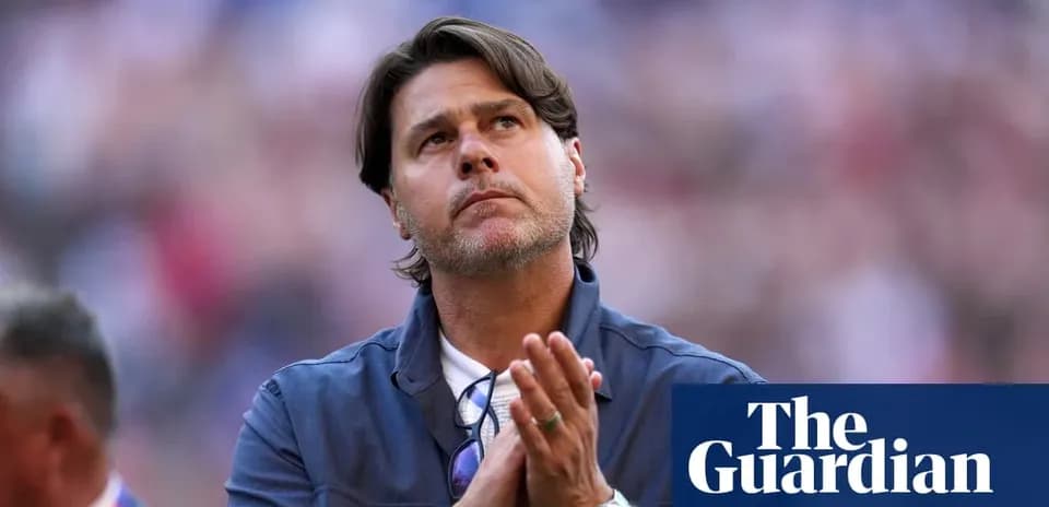 Men's football coach looking up during match