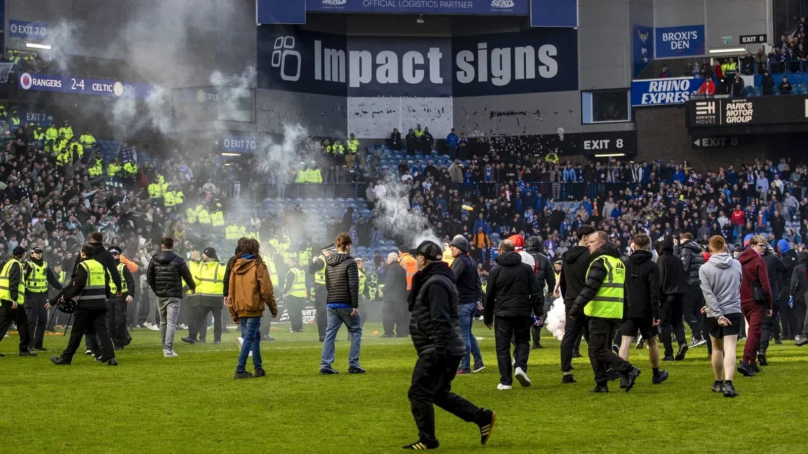 Fans and security on the pitch after match
