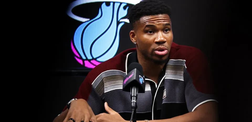 Basketball player speaking at press conference podium
