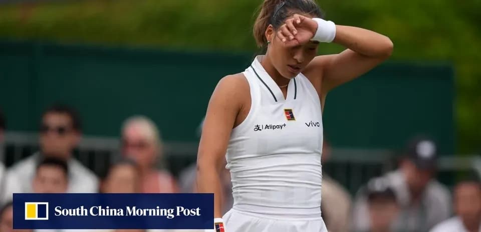 Tennis player wiping forehead during match