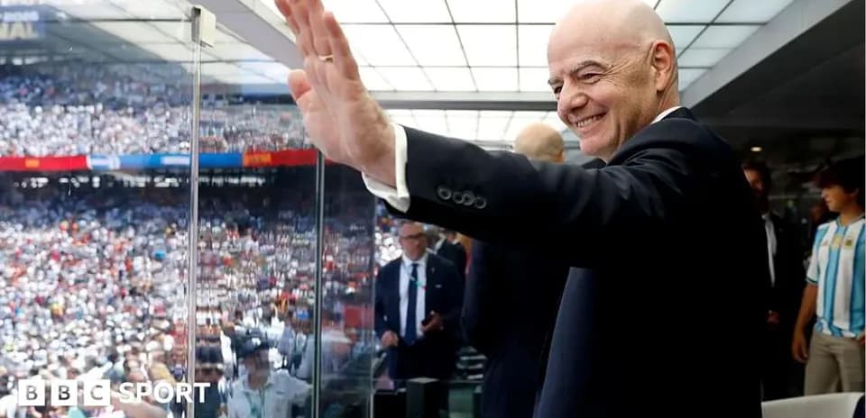Person waving from VIP box at stadium