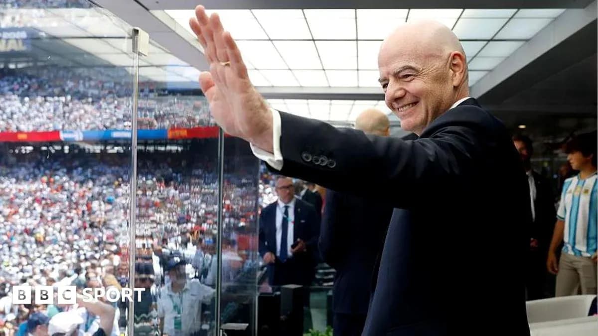 Person waving from VIP box at stadium