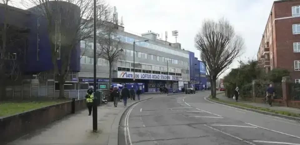 Loftus Road Stadium exterior with pedestrians and vehicles