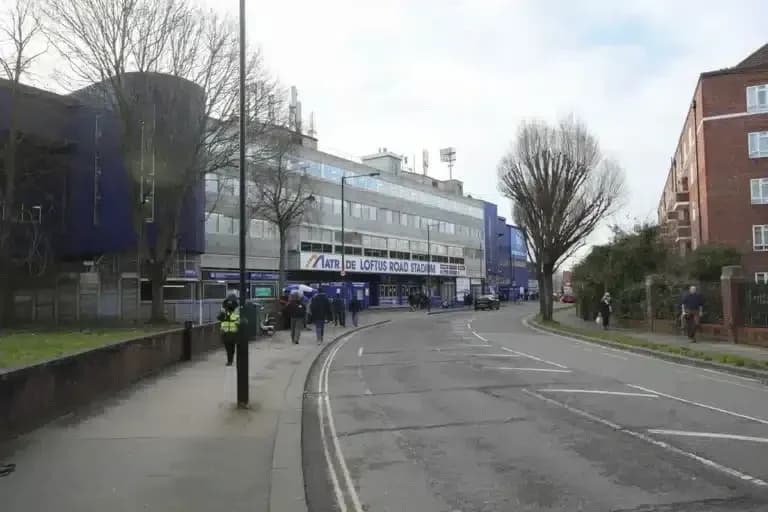 Loftus Road Stadium exterior with pedestrians and vehicles