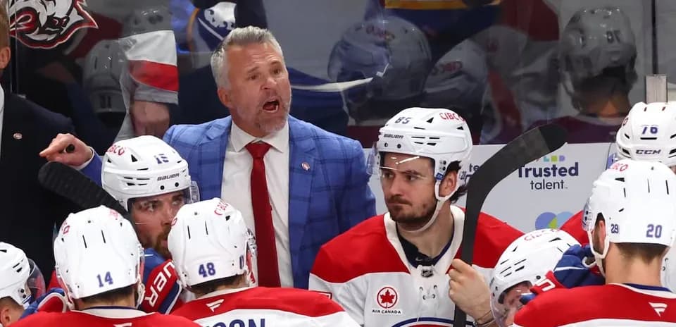 Hockey coach instructing players during team huddle