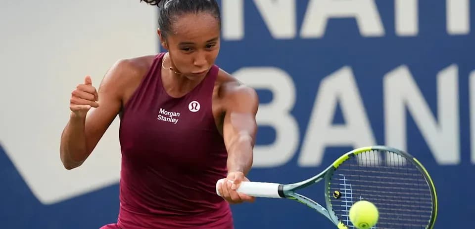 Tennis player hitting a forehand shot during match