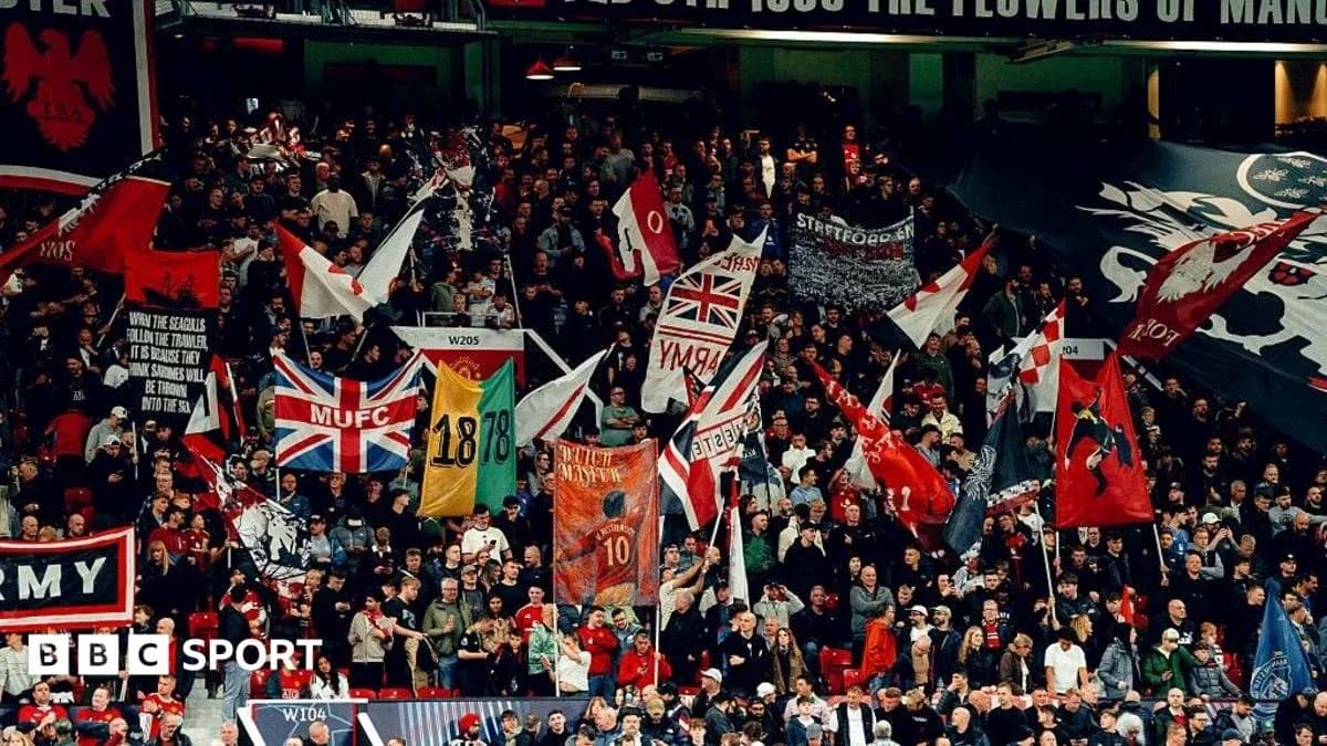 Football fans waving flags in stadium stands