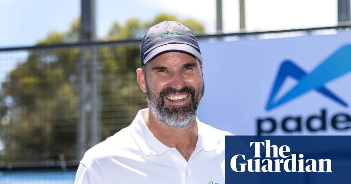 Man smiling at padel event with branding in background