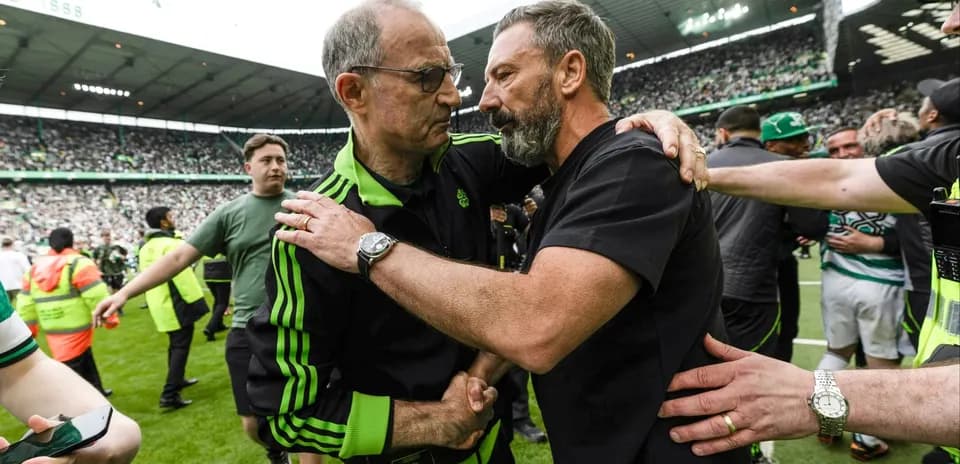Coaches embracing on the pitch after match