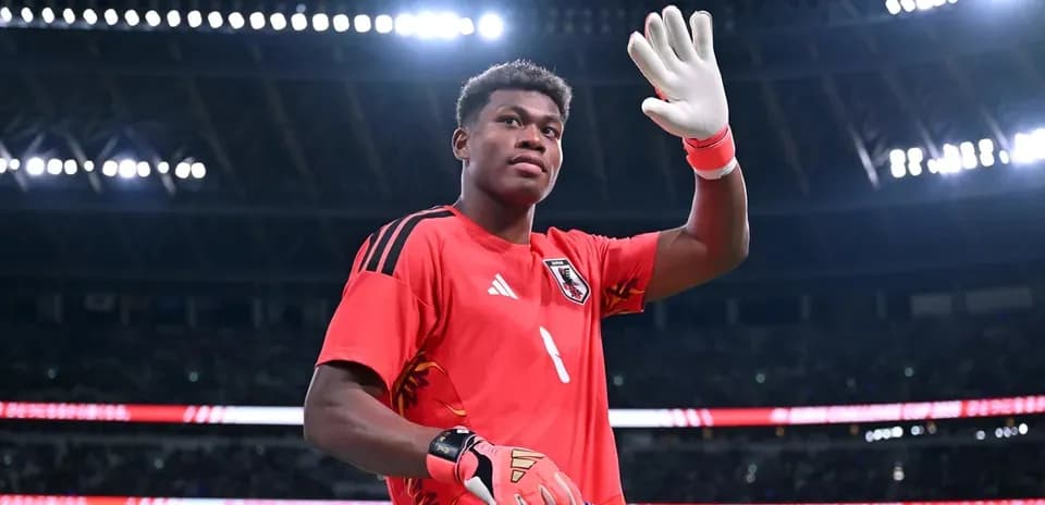 Goalkeeper waving with gloves at stadium