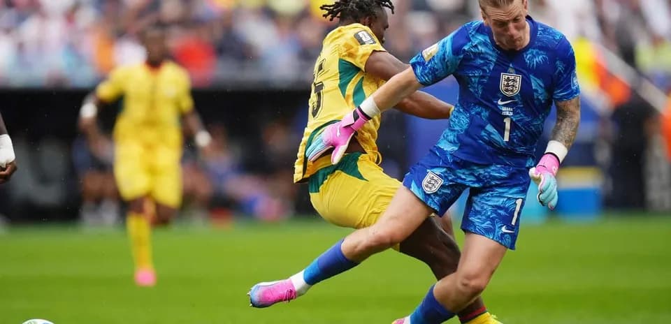 Goalkeeper and player colliding during football match
