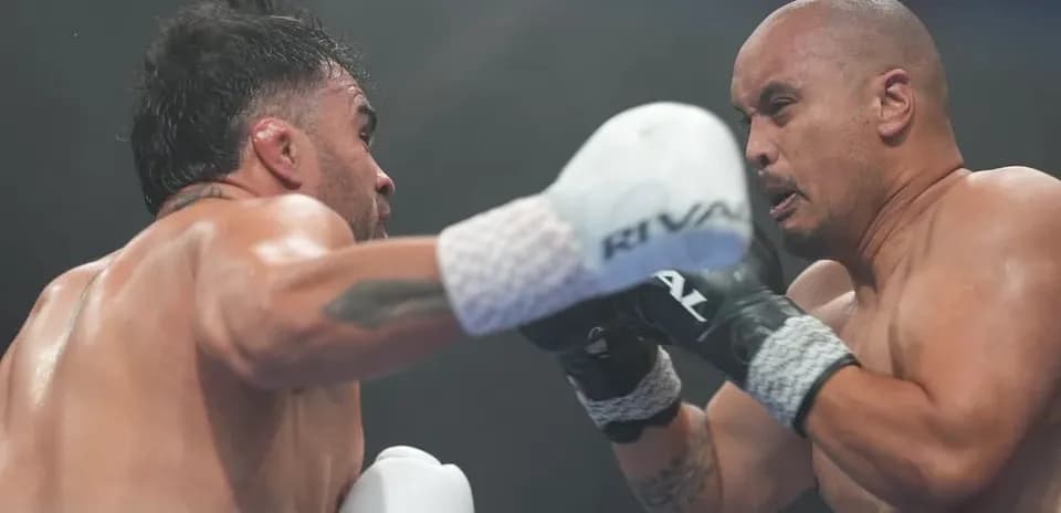 Two boxers exchanging punches in the ring