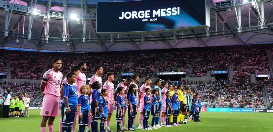 Players and children lined up before the match