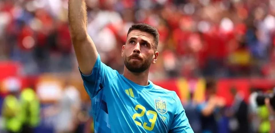 Goalkeeper raising hand during match celebration