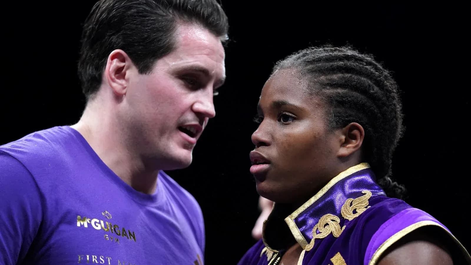Boxer receiving instructions from coach before match