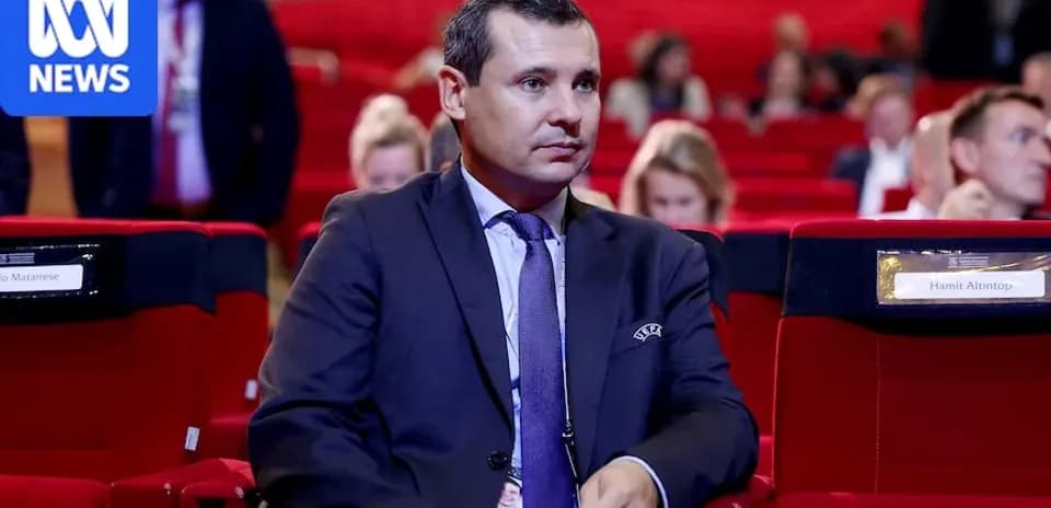 Man sitting in conference hall among attendees