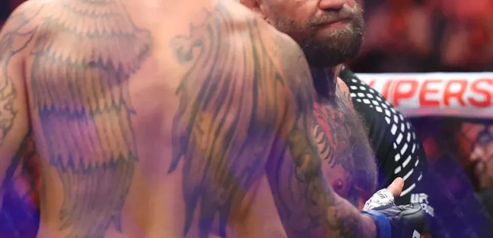 MMA fighters interacting in the octagon after match