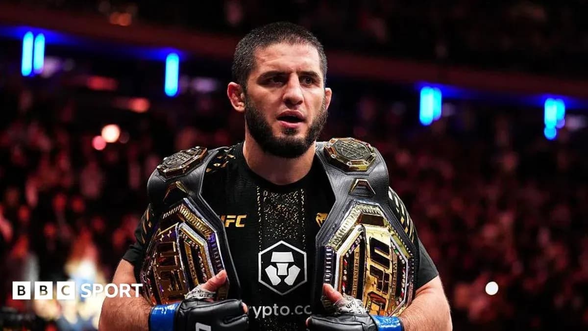 UFC fighter holding two championship belts UFC fighter holding two championship belts