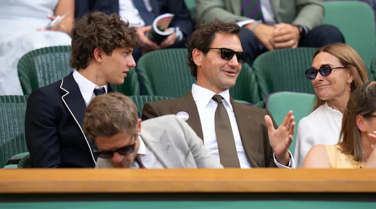 Group of people seated at Wimbledon event Group of people seated at Wimbledon event