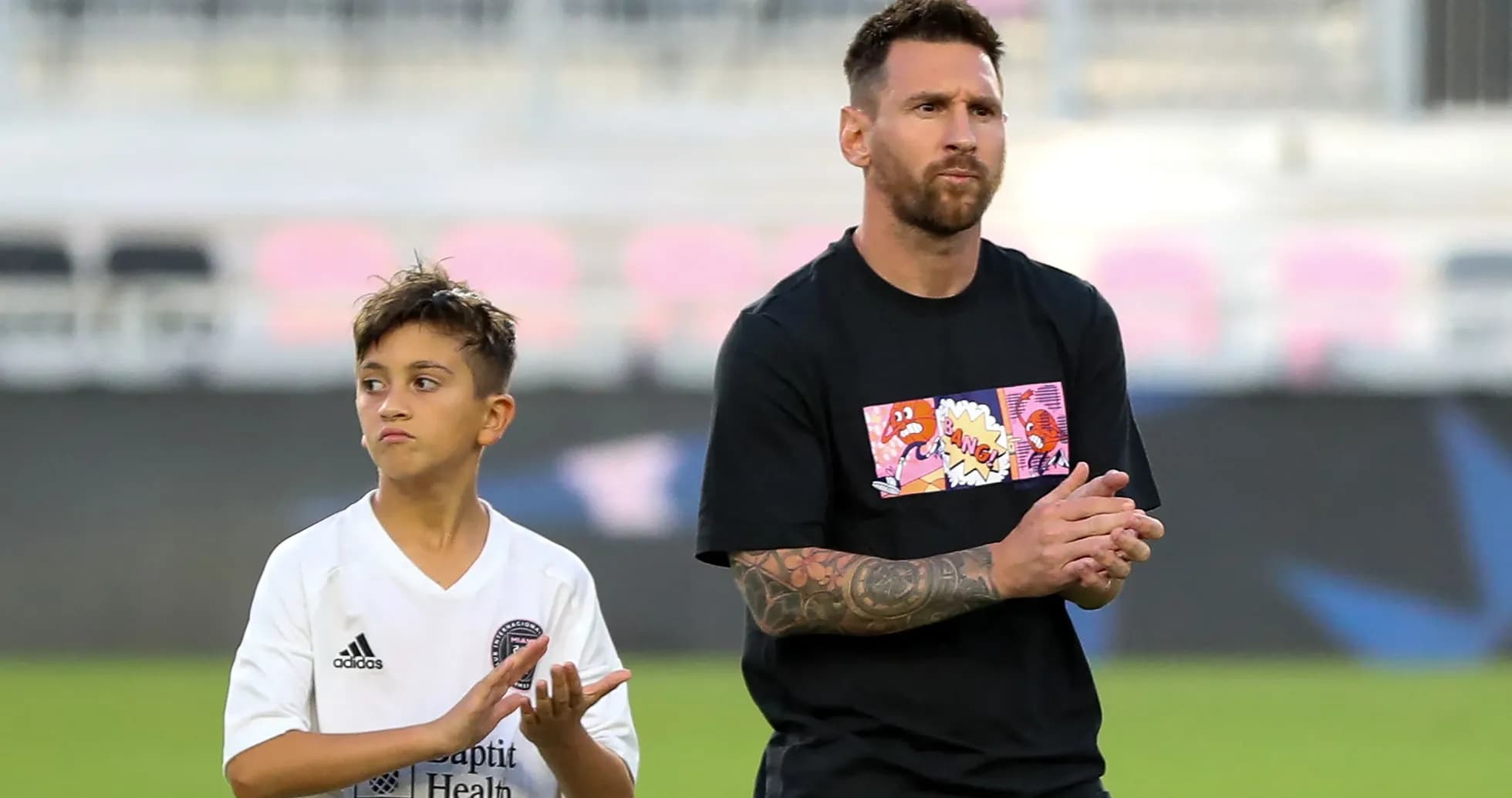 Lionel Messi with a young player at stadium Lionel Messi with a young player at stadium
