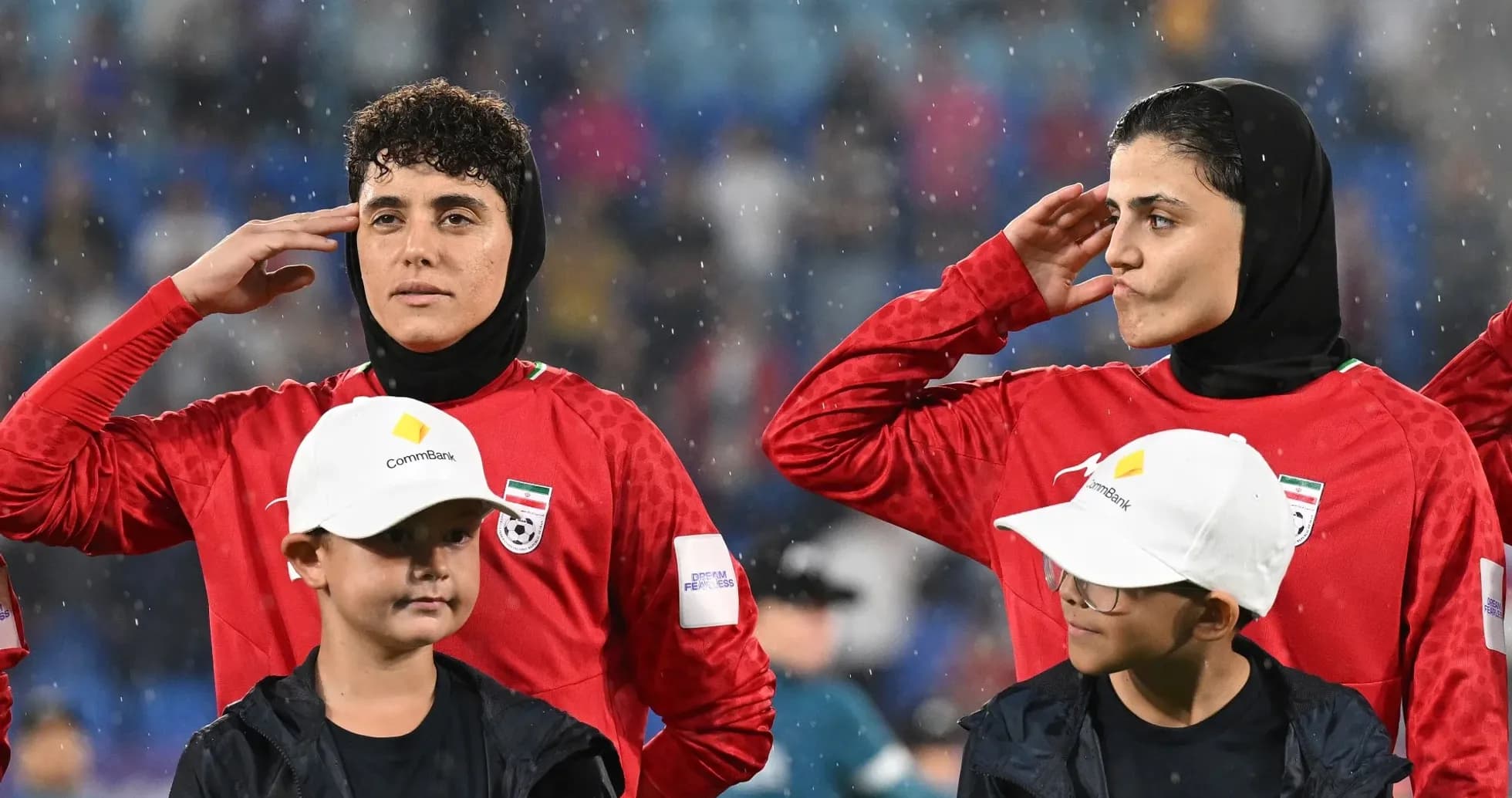 Female players saluting during national anthem ceremony Female players saluting during national anthem ceremony