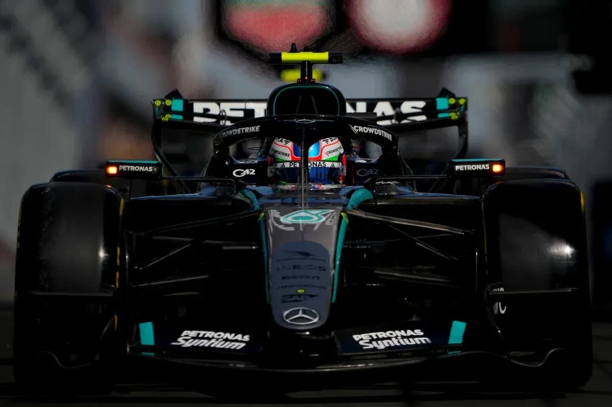 Formula 1 car racing on track with driver visible Formula 1 car racing on track with driver visible