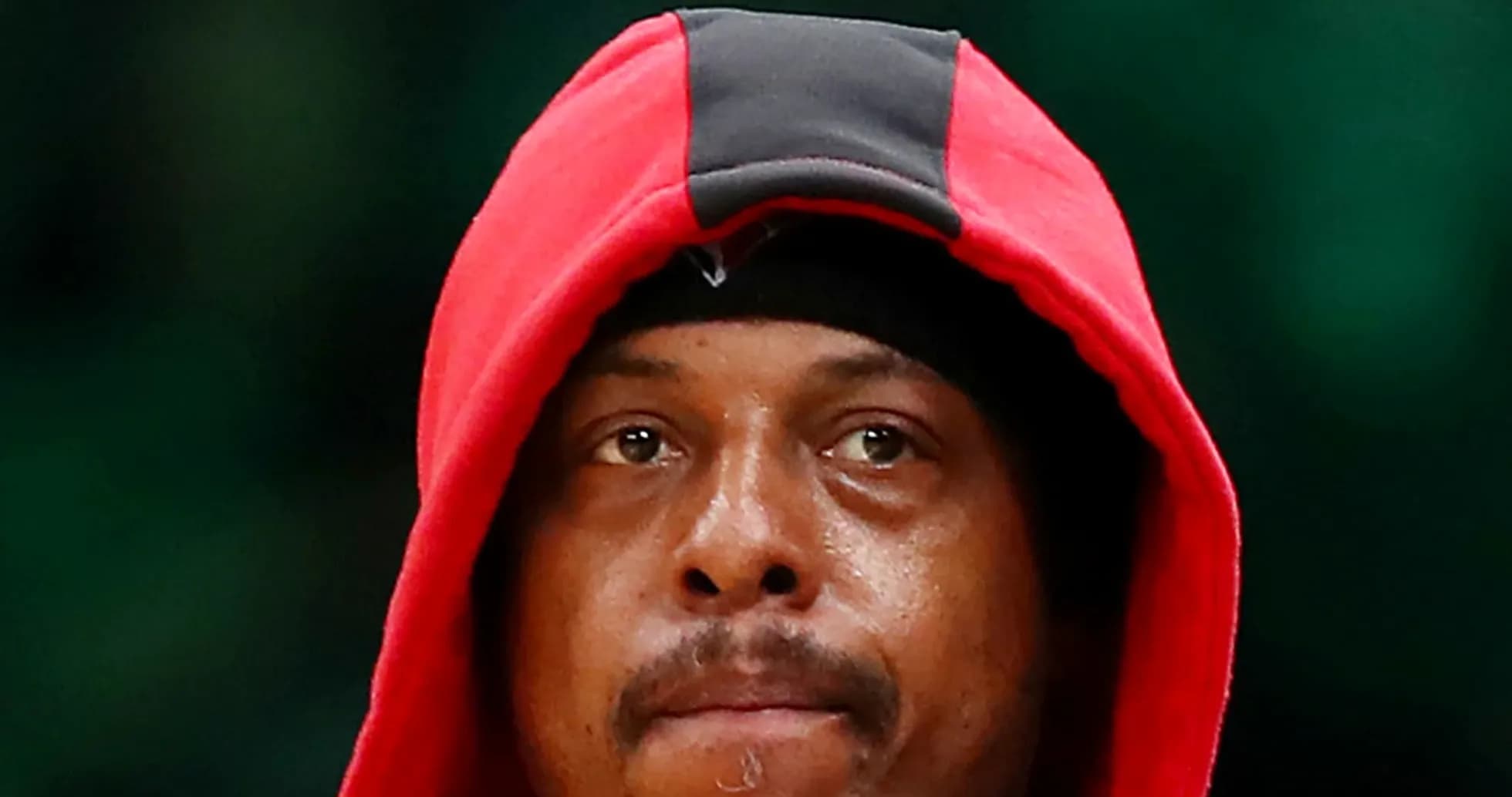 Basketball player wearing a red hoodie on court Basketball player wearing a red hoodie on court