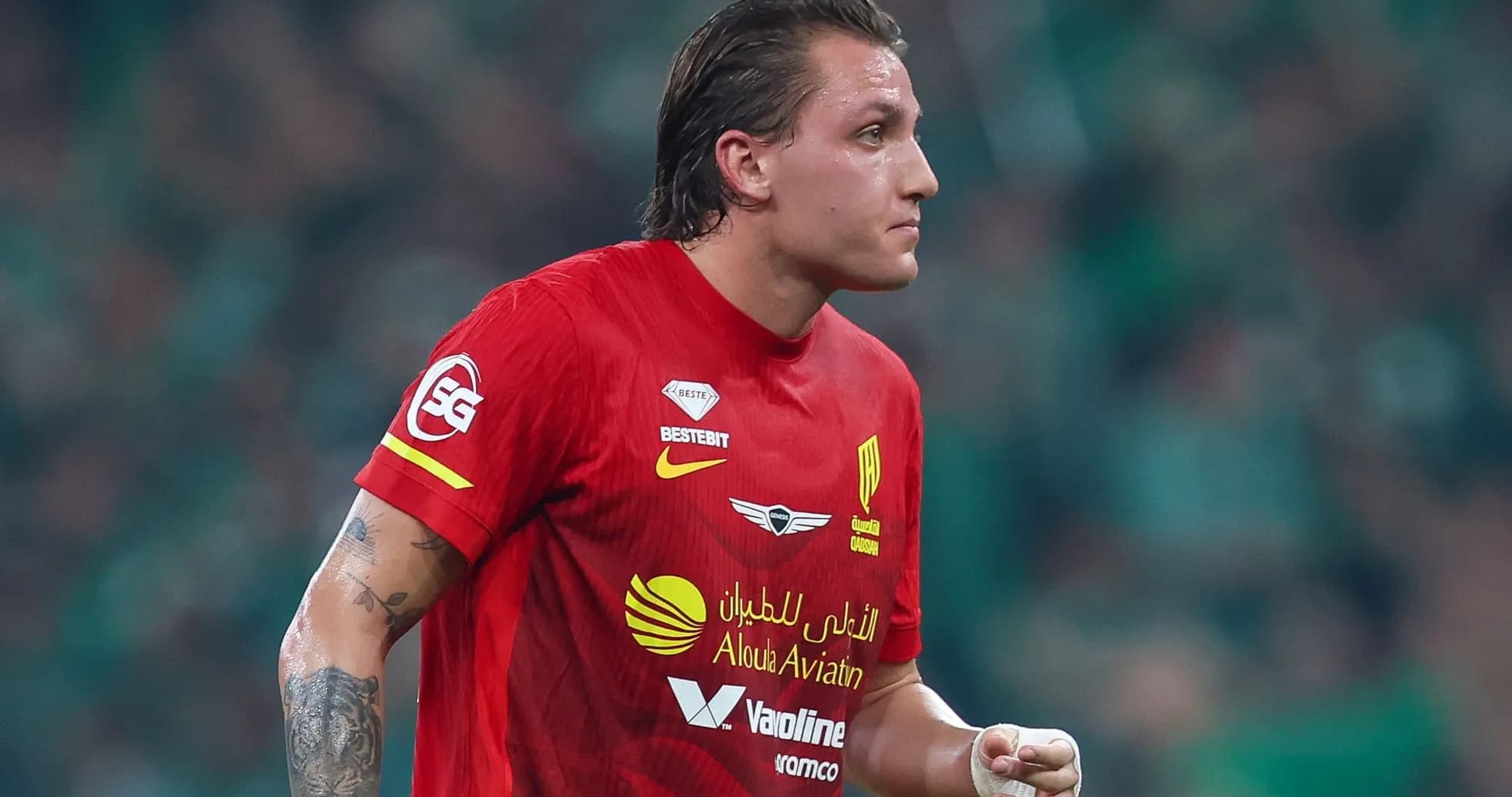 Futbolchi qizil forma bilan maydonda harakatda Futbolchi qizil forma bilan maydonda harakatda