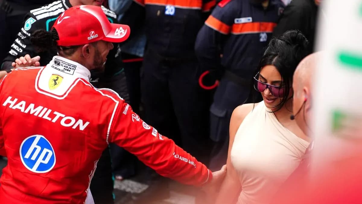 Formula 1 driver interacting with a woman in paddock Formula 1 driver interacting with a woman in paddock